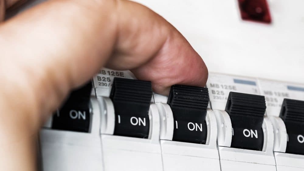 Up close look at a finger switching a sub panel circuit from ON to OFF
