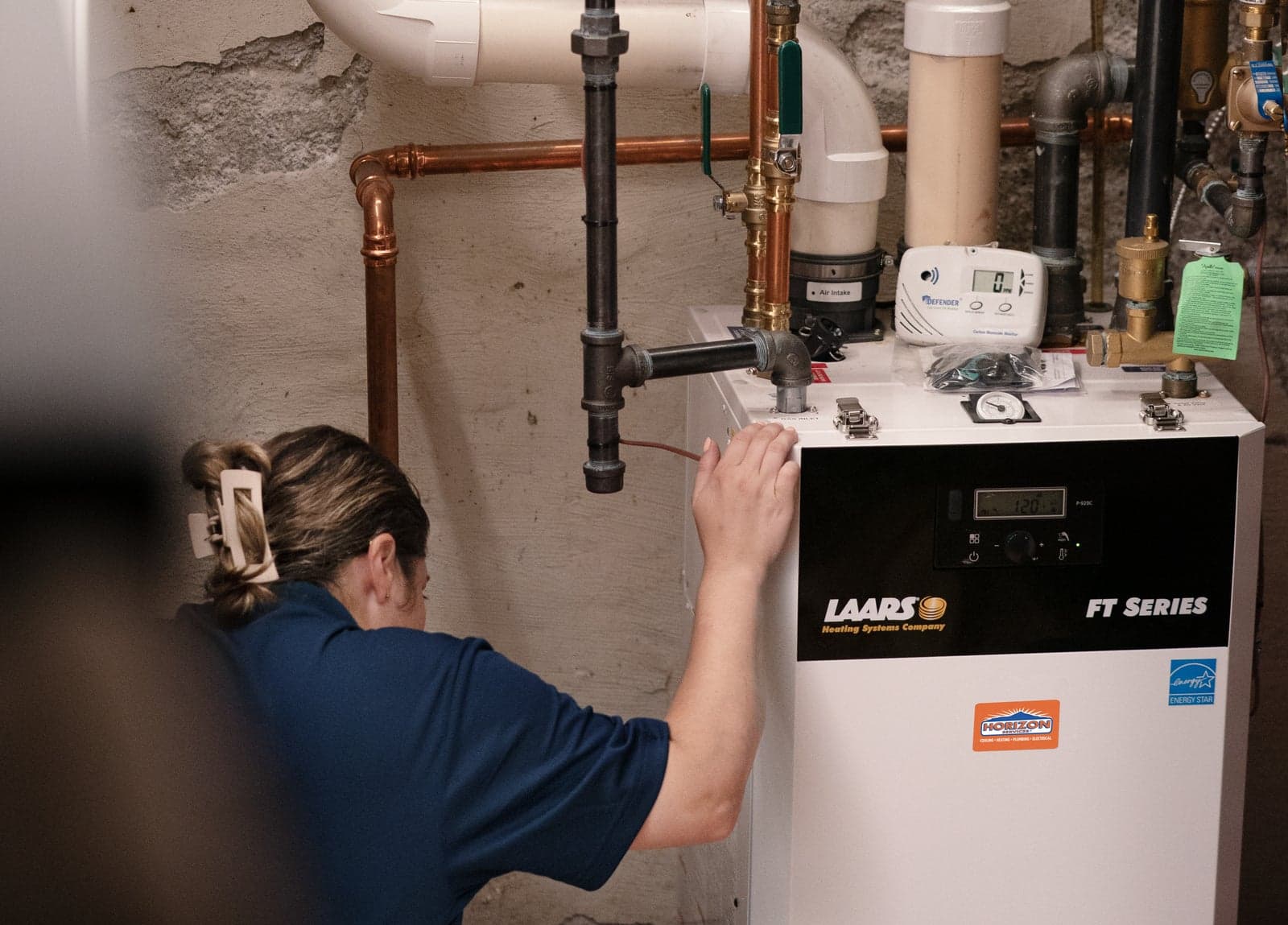 A Horizon Services technician checking a high-efficiency boiler