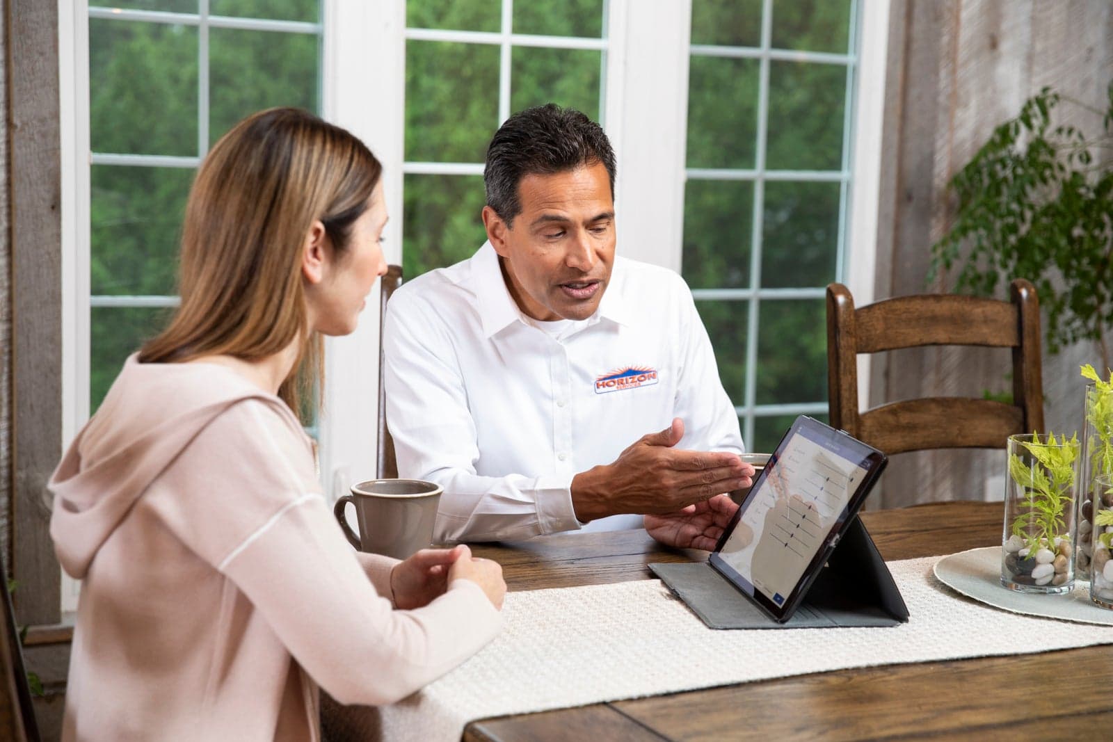 A Horizon Services comfort consultant reviewing project details with a homeowner