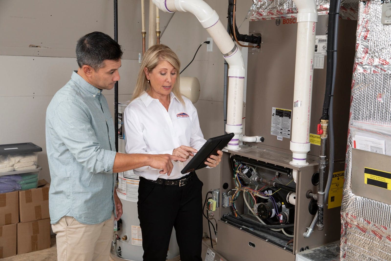 A Horizon Services comfort consultant reviewing furnace options with a homeowner