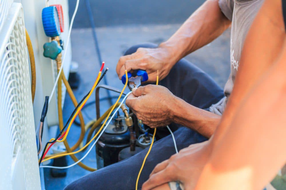 Horizon technicians working on a malfunctioning air conditioner unit