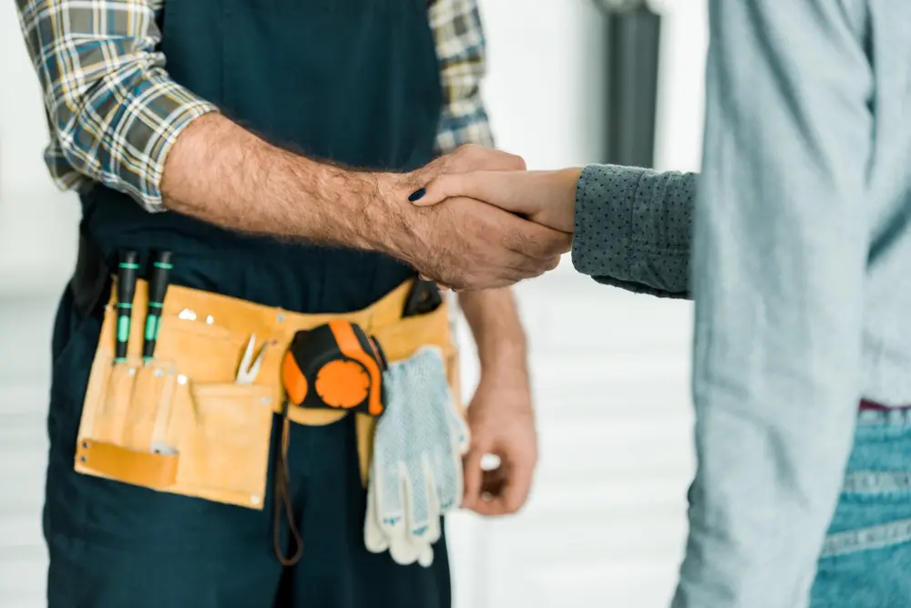 A technician exchanging a handshake with a homeowner