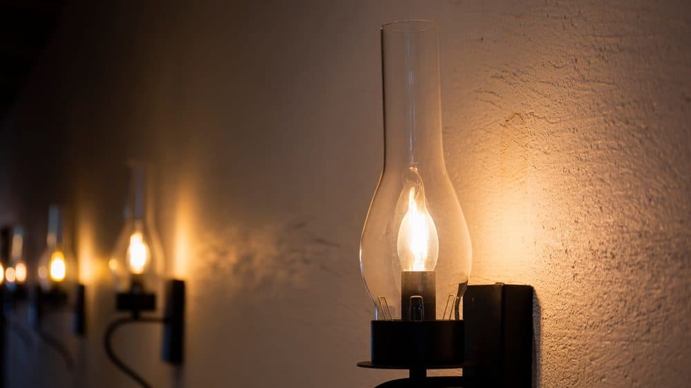 4 wall sconces in a row with warm lighting