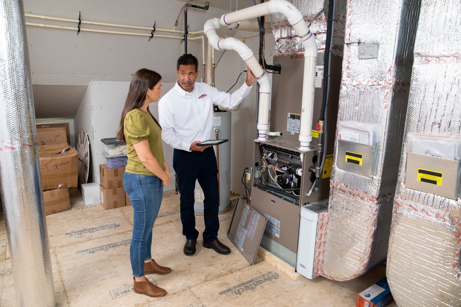 A Horizon Services comfort consultant showing a homeowner a high-efficiency furnace