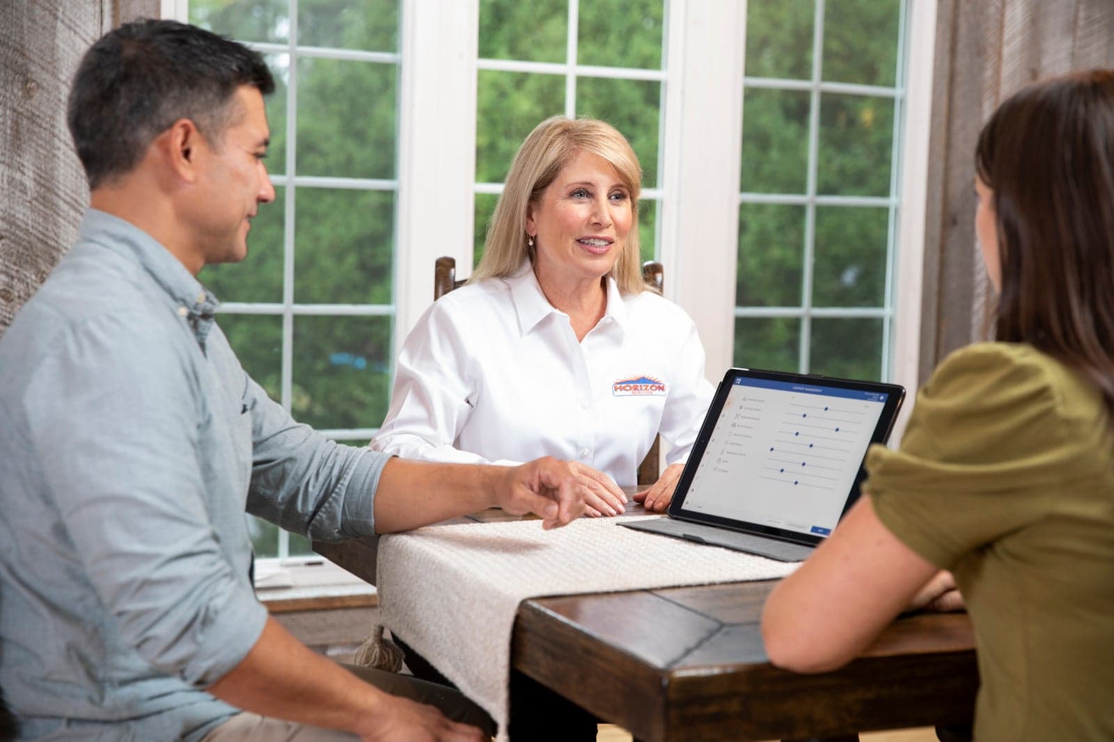 A Horizon Services comfort consultant walking homeowners through coverage paperwork