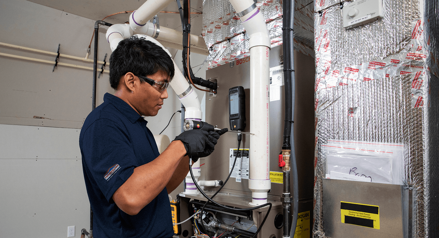A man working on a heating unit