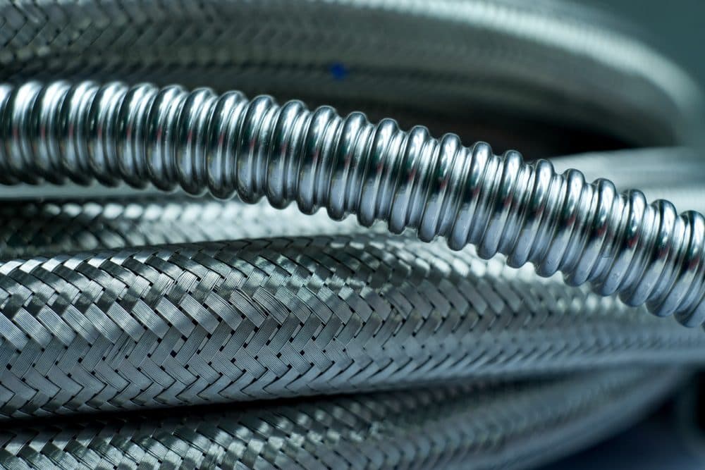 An assortment of flexi hoses sitting horizontally