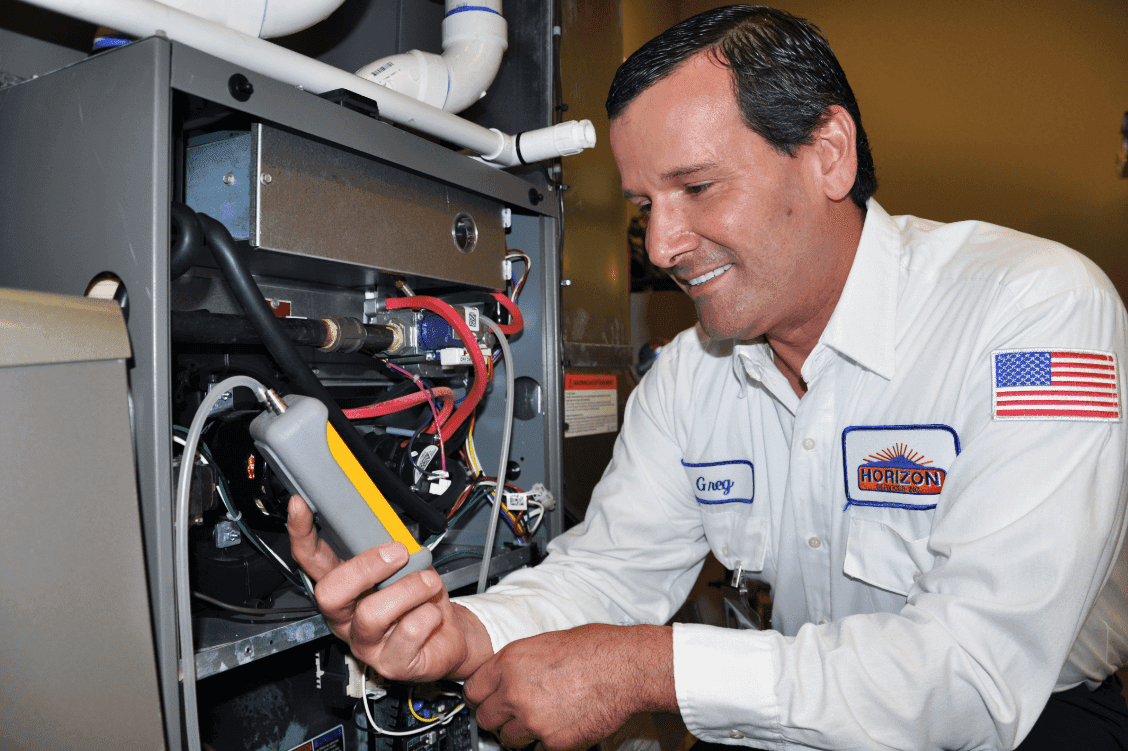 Smiling Horizon technician performing a heating tune up